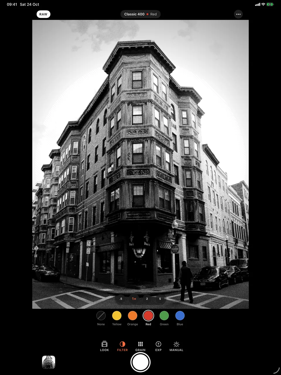 B&W Camera on iPad with the red filter selected over a brick corner building